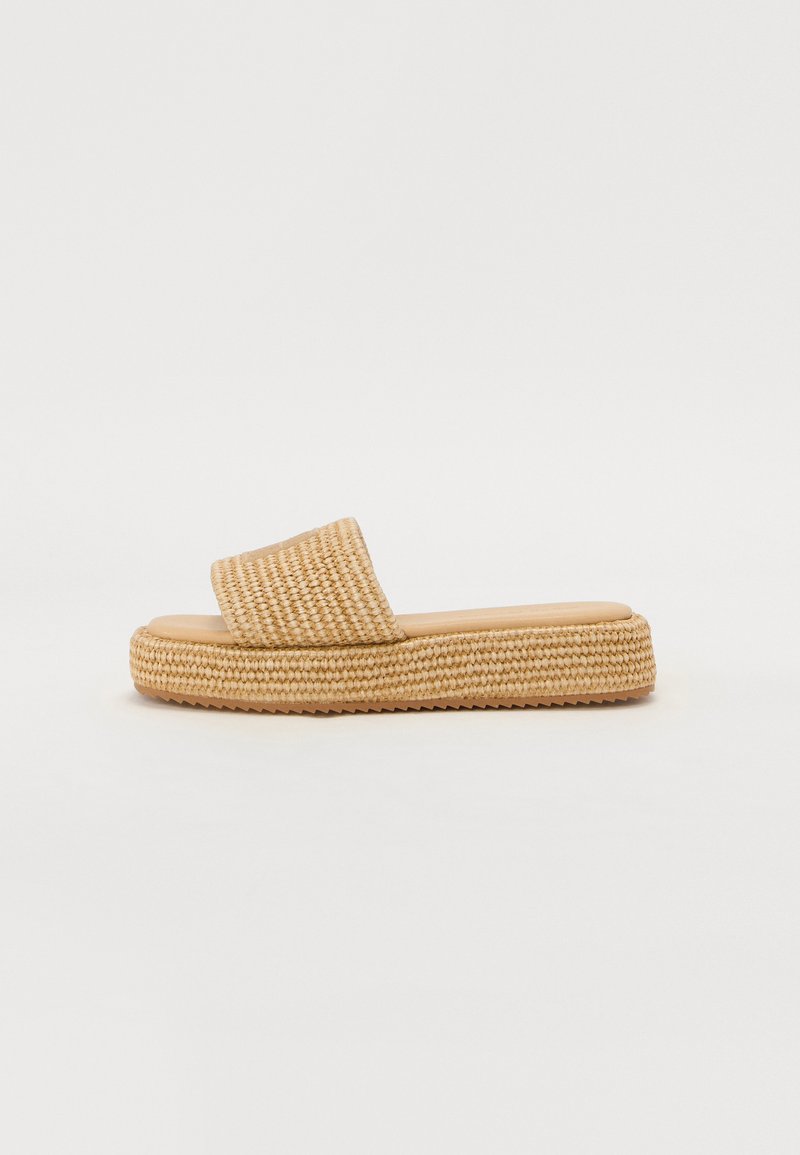 Woven straw slide sandals with a wide strap, light beige color, cushioned insole, and textured jute platform sole.