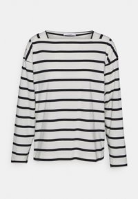 Long-sleeve shirt in white cotton with horizontal black stripes. Features a wide neckline and straight-cut hem. Soft texture and relaxed fit.