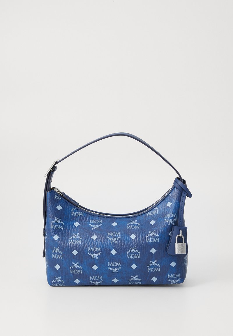 Sac à main en cuir bleu avec une forme incurvée, fermeture éclair et motifs décoratifs de diamants et de logos. Comprend un petit détail en forme de cadenas.