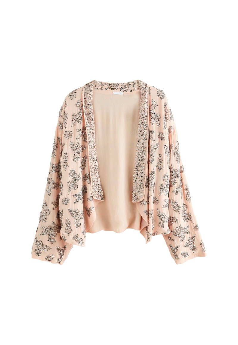 Cardigan rose clair ouvert sur le devant avec manches longues et motifs floraux en sequins argentés sur le tissu et la bordure.