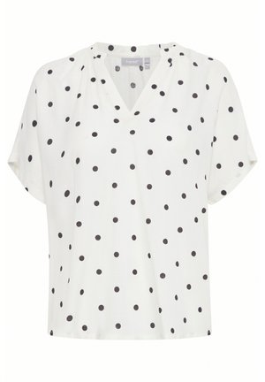 Haut blanc à manches courtes avec un col en V, présentant un motif à pois noirs. Fabriqué dans un tissu léger avec une coupe décontractée.