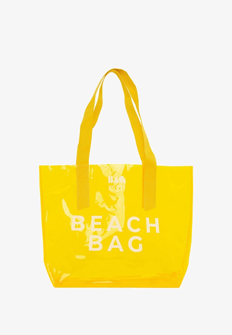 Žltá priehľadná plážová taška s dvoma pevným textilnými rúčkami a nápisom "BEACH BAG" tučným bielym písmom na prednej strane.
