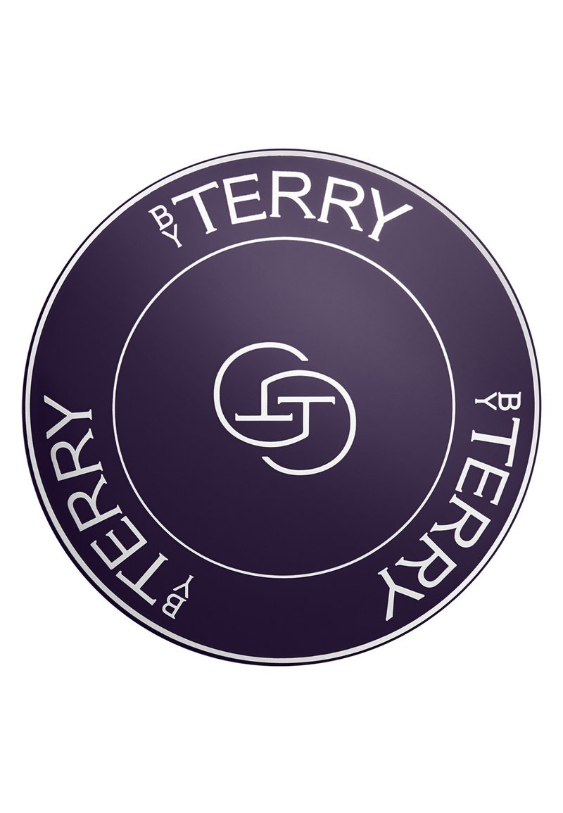 Produit rond violet avec le texte blanc "by Terry." Le logo central présente les lettres entrelacées "G" et "S." Surface lisse avec une finition brillante.
