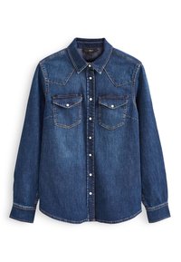 Denim shirt in dark blue with a pointed collar, long sleeves, two chest pockets, and white snap buttons, featuring contrasting stitching details.
