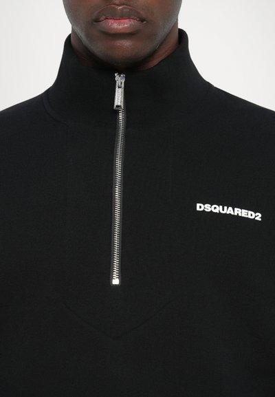Zwarte colbert met ritssluiting, gemaakt van een gladde stof, met een zilveren rits en een wit "DSQUARED2" logo op de linkerkant van de borst.