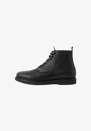 Black leather ankle boot with laces, smooth rounded toe, and pull tabs on tongue and heel, shown from the side on a white background.