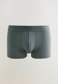 Boxer aderenti grigi scuri da uomo con una ampia vita goffrata con il nome del marchio "NEXT" su uno sfondo chiaro.