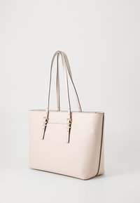 Beige leather tote bag with two long straps, featuring gold hardware accents and a smooth texture, with a structured rectangular shape.