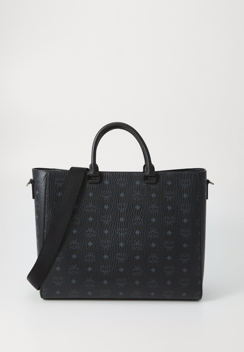 Svart läder tote-väska med texturerad yta, med dubbla handtag och en avtagbar axelrem. Diskret logotypmönster genom hela väskan.