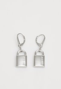 Silver metal earrings shaped like padlocks with a polished finish, featuring a lever-back closure and engraved branding on the front.