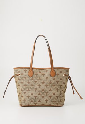 Beige tote bag made of textured fabric, featuring a patterned design in brown, complemented by brown leather accents and handles.