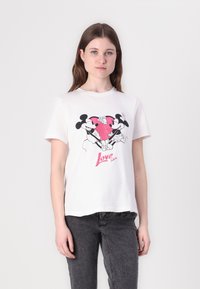 White cotton t-shirt featuring a graphic print of Mickey and Minnie Mouse holding a pink heart, with "Love" in red cursive text beneath.