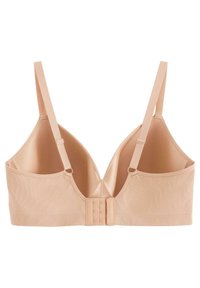 Beige rintaliivi saumattomalla suunnittelulla, säädettävillä hihnoilla ja hakasella selässä; valmistettu sileästä, venyvästä kankaasta.