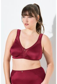 Bordeauxfarbenes BH mit gerippter Textur, durchsichtigen Mesh-Panels und dekorativen Spitzelementen. Verfügt über breite Träger und einen zentralen dekorativen Knopf.