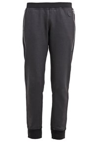 Schwarze Jogginghose aus weichem Stoff, mit seitlichen Reißverschlüssen, elastischem Bund und Bündchen, mit glatter Textur und schlankem Schnitt.
