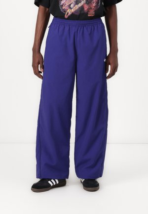 adidas Originals ADILENIUM SEASONAL 3 OVERSIZED SUPERSTAR TRACK - Tracksuit bottoms - night indigo