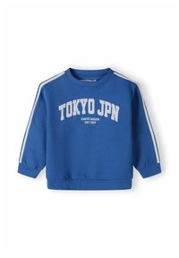 Modra sreč kardigan s okroglim izrezom, belim napisom "TOKYO JPN" in belimi črtami ob rokavih. Narejen iz mehkega, teksturiranega blaga.