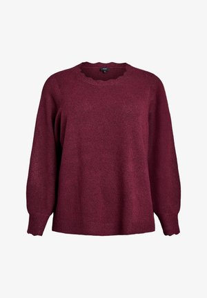 Naiste burgundia punane kudum, millel on pikad varrukad, laineline ümar kaelus ning soonikkoes mansetid ja helmes valgel taustal.