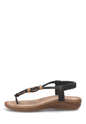 Sandalia plana para mujer en tonos marrón y negro con correa elástica en el tobillo y tiras decorativas de cuero trenzado sobre una suela acolchada.