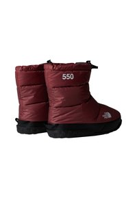 Bottes isolées rouges avec un dessus à motif, semelle en caoutchouc noir et marquage blanc. Caractéristiques : un haut resserré et une languette de tirage pour un enfilage facile.