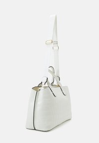 White faux crocodile leather handbag with a structured design, gold hardware, and a detachable strap featuring a logo.