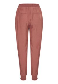 Lichte, roestkleurige broeken met een elastische tailleband, twee achterzakken en gerimpelde zoom voor een relaxte pasvorm. Zachte textuur, geen zichtbare patronen.