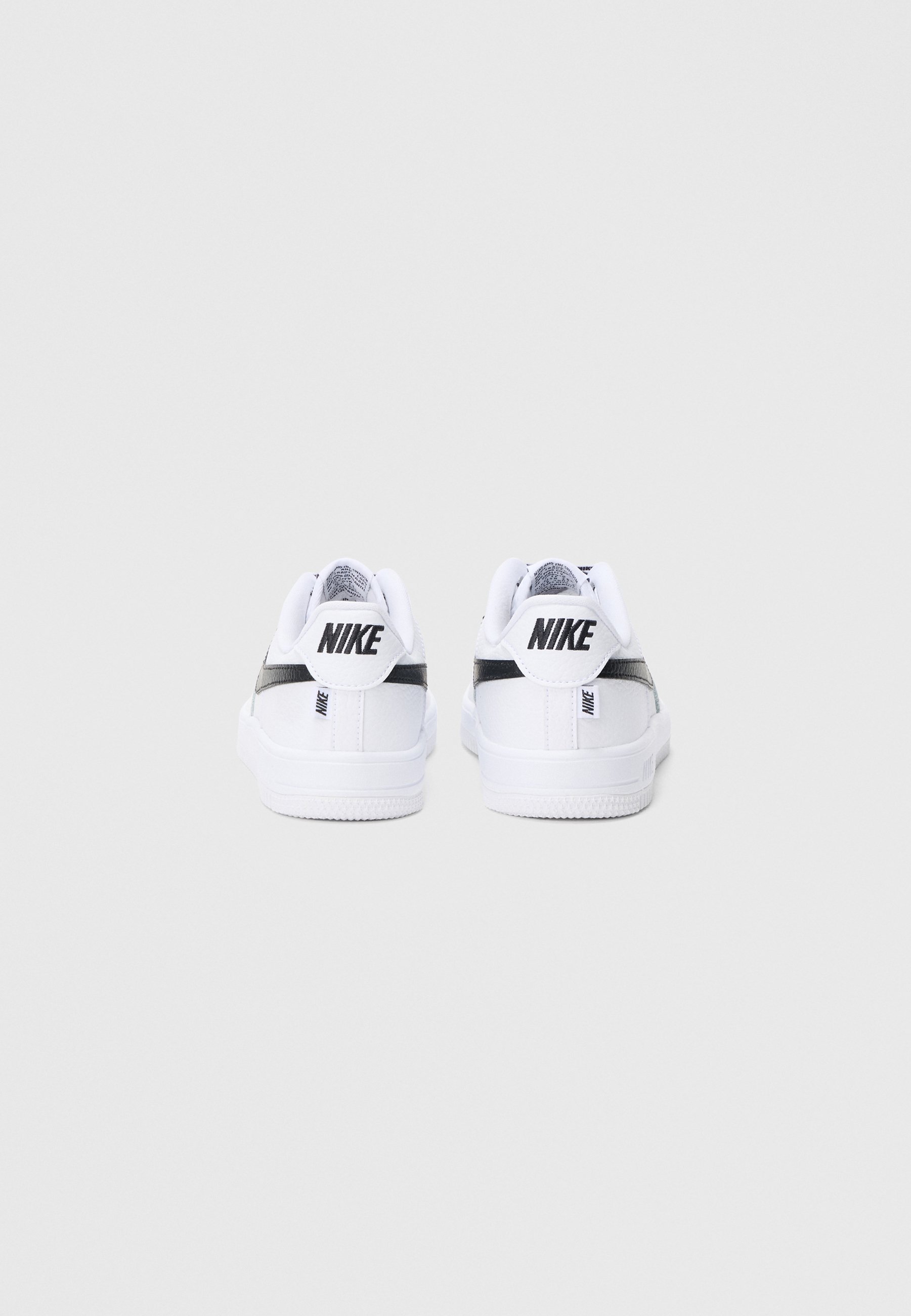 white nike low cut shoes