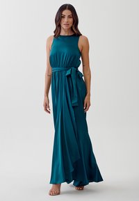 Teal, sleeveless maxi dress with a fitted bodice, gathered waist, and a flowing skirt. Includes a matching waist tie. Smooth, lightweight fabric.