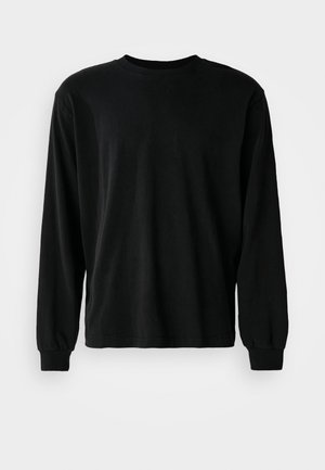 Black long-sleeve shirt made of cotton, featuring a crew neck, relaxed fit, and fitted cuffs, with a smooth texture and no visible patterns.