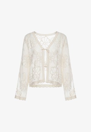 Transparenter cremefarbener Cardigan mit langen Ärmeln, floralem Spitzenmuster, geschwungenen Kanten und kleinem Binderverschluss vorne.