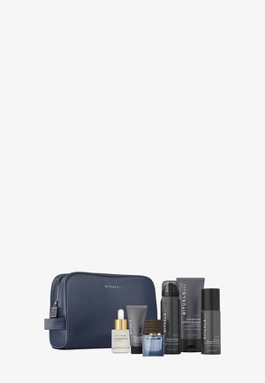 Navy cosmetic bag with a textured finish, containing six grooming products, including a serum, shampoo, and cream, with gold and black accents.