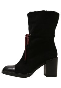 Black suede ankle boot with a high block heel, featuring a contrasting black leather toe cap and a burgundy lace for adjustment.
