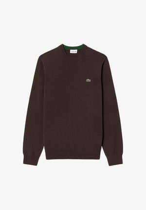 Tummanruskea pitkähihaisen pyöreäkauluksinen neule, jossa vasemmassa rinnassa pieni vihreä krokotiililogotunnus ja resorit hihansuissa sekä helmassa.