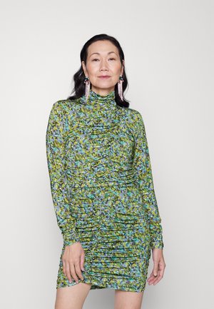 Πράσινο φόρεμα με λουλούδια, με μακριά μανίκια, ψηλή λαιμόκοψη και ραφές. Περιέχει έντονα μπλε και μωβ στοιχεία.