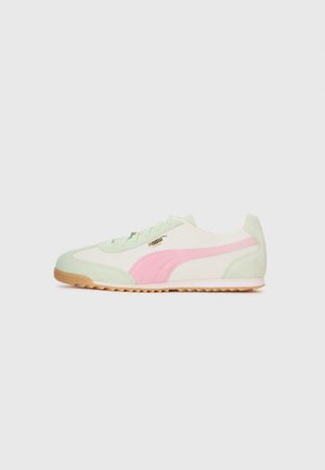 Low-top sneaker with cream and pastel green suede, pink side stripe, gum sole, and gold Puma logo on the side.