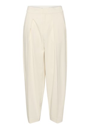 Krēmkrāsas piegrieztas bikses ar augstu jostasvietu, sūkņotu priekšpusi un sašaurinātām kājām. Izgatavotas no gludas auduma bez rakstiem vai rotājumiem.