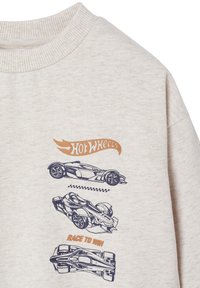 Light beige sweatshirt with ribbed collar featuring three graphic car illustrations in navy and a "Hot Wheels" logo in orange.