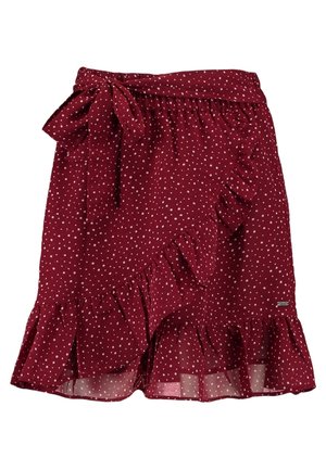 Jupe portefeuille bordeaux à pois blancs, bordures volantées et ceinture nouée à la taille.