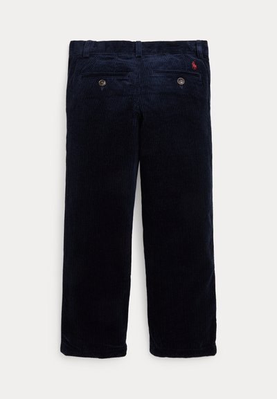 Pantalones de pana azul marino con textura de ribetes verticales, que presentan dos bolsillos traseros y un pequeño logo bordado en rojo en la cinturilla.