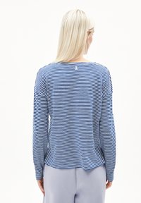 Blue and white striped long-sleeve shirt with a round neckline, featuring a small logo detail at the back. Soft, lightweight fabric.