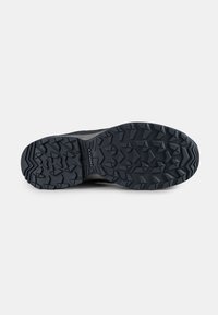 Black athletic shoe sole with a textured rubber surface, featuring deep treads and angular patterns for enhanced grip and traction.