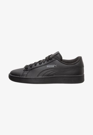 Zapatilla Puma negra de perfil bajo con cordones delanteros, cuello acolchado y logo Puma sutil en el lateral y la suela, vista desde el lado exterior.