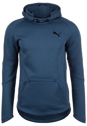Granatowa bluza z kapturem, przednia kieszeń na zamek, kieszeń kangurka, długie rękawy oraz czarne logo Puma na piersi.