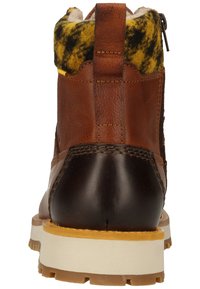 Brown leather ankle boot with a textured yellow and black faux fur collar. Features a back zipper, white midsole, and sturdy rubber outsole.