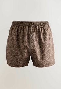 Boxersice s uzorkom leoparda, s elastičnim pojasom i kopčanjem na dugme. Tkanina u smešnim tonovima s malim tamnim mrljama. Glatka tekstura.