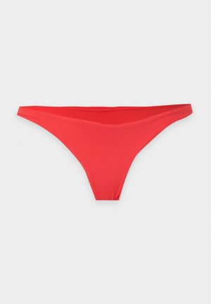 String rouge sans couture taille basse sur fond blanc, vue de face avec tissu lisse et coutures minimales.