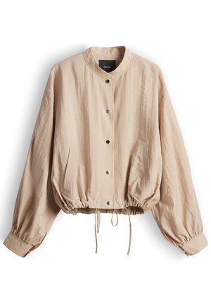 Giacca leggera beige con bottoni a pressione, orlo con coulisse elastica, maniche lunghe a sbuffo con polsini abbottonati e due tasche laterali.