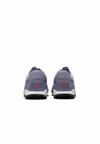 Purple athletic shoes feature a textured upper, contrasting gray outsole, and red accents on the heel. Designed for comfort and durability.