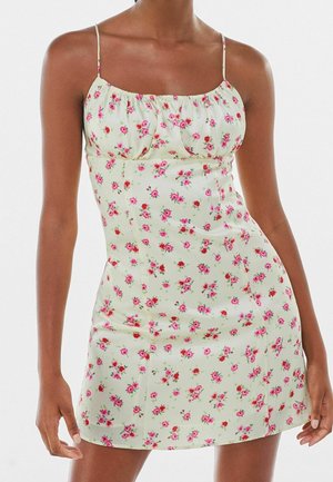 Slim-fit sleeveless floral dress with thin straps, featuring a light background and small pink and red flower patterns.
