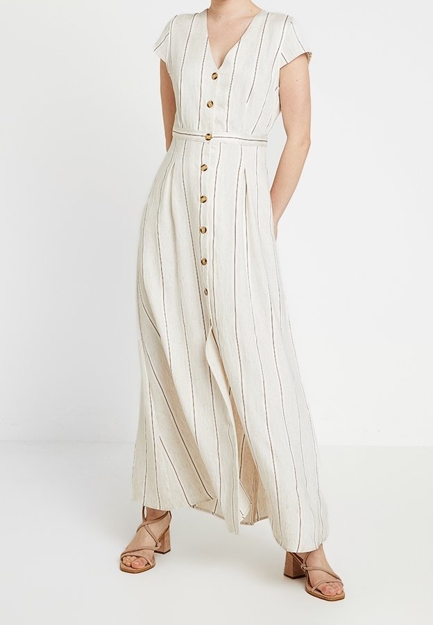 Maxi dress in light beige with vertical stripes. Features short sleeves, a V-neck, a button front, a waist tie, and wooden buttons.